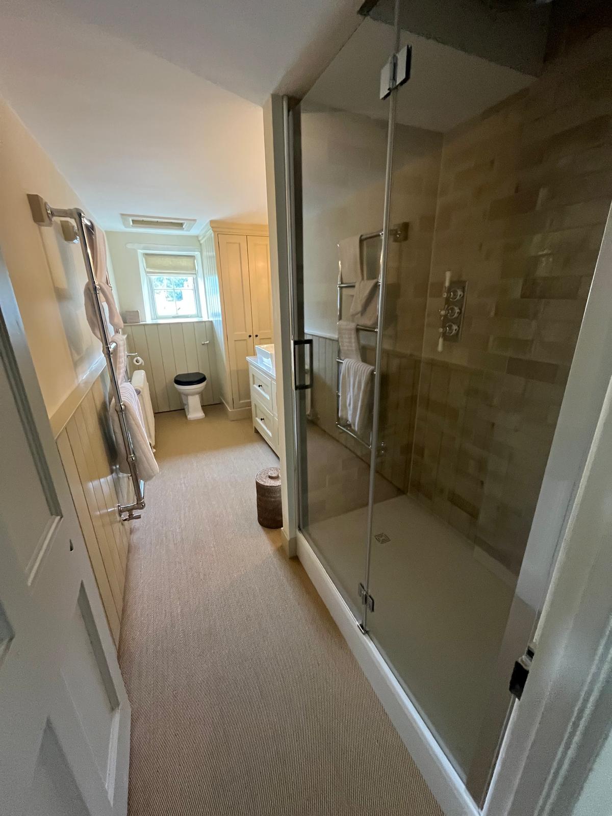 Family bathroom with walk-in shower and cream panelling