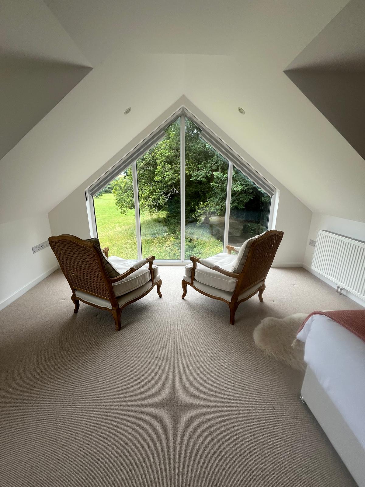 Cosy snug with armchairs and garden views